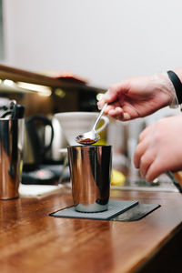 Hand holding coffee cup on table