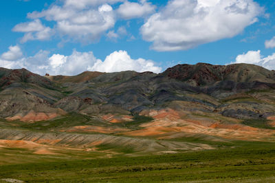 Scenic view of mountains against cloudy sky