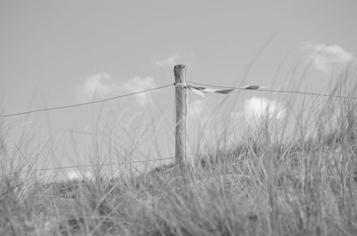 Fence on field against sky