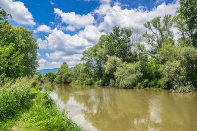 Scenic view of lake against cloudy sky