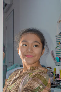 Portrait of a young girl looking at herself in the mirror 