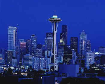 Space needle and modern buildings in city against clear blue sky