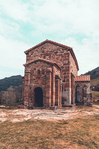 Old ruins of building against cloudy sky