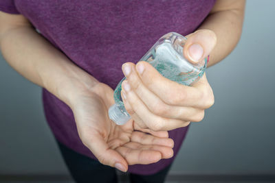 Midsection of woman holding ice cream cone