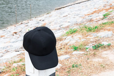 Rear view of person wearing hat on rock