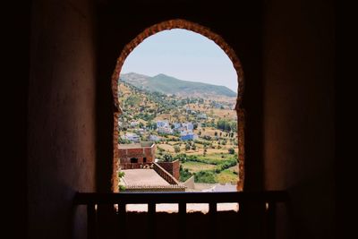 Buildings seen through arch window