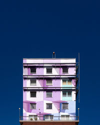 Low angle view of building against clear blue sky