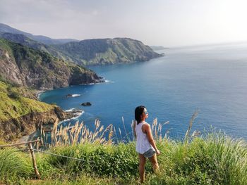 Rear view of woman looking at sea on mountain