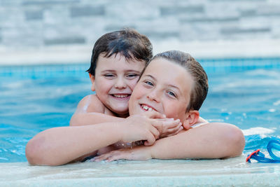 Portrait of mother and daughter at swimming pool