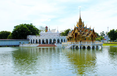 View of temple by building against sky