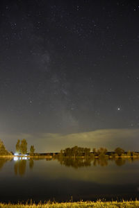 Scenic view of lake against star field at night