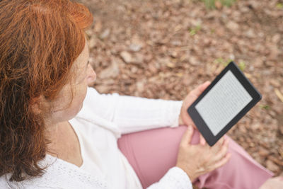 Midsection of woman using mobile phone