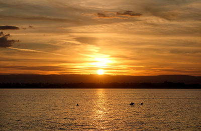 Scenic view of sea against orange sky