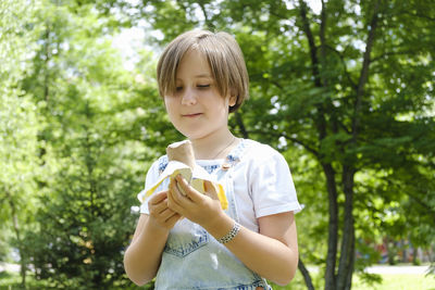 Teenage girl on a walk on a summer day in the park to enjoy ice cream