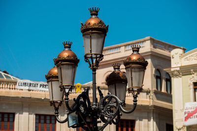 Low angle view of street light against building