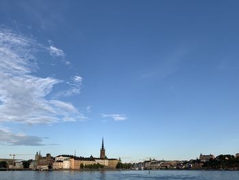 Buildings in city against blue sky