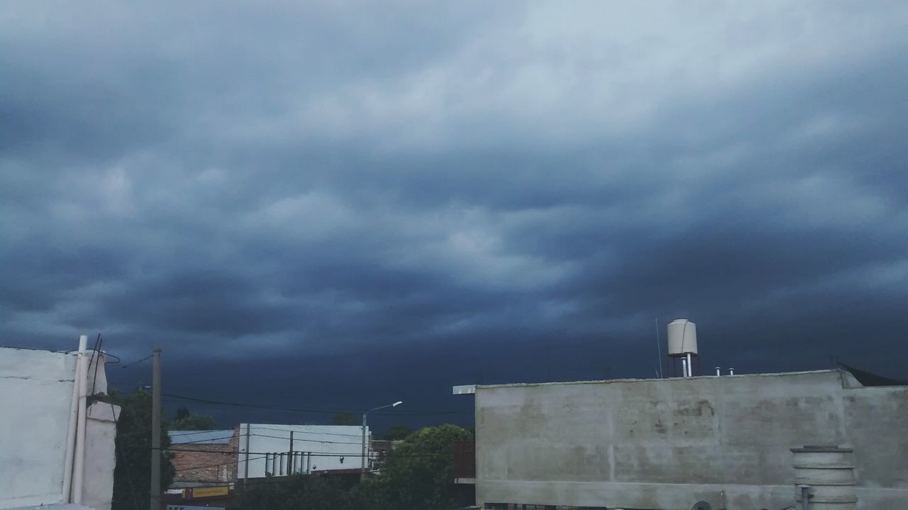 sky, architecture, cloud - sky, cloudy, built structure, building exterior, weather, low angle view, overcast, storm cloud, cloud, building, house, dusk, outdoors, no people, cloudscape, nature, day, residential structure