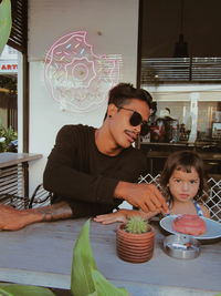 Happy girl and son on table