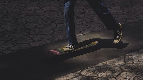 Low section of people walking on footpath