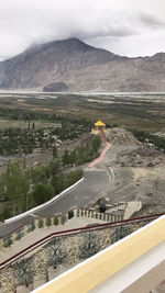 High angle view of road by mountains against sky