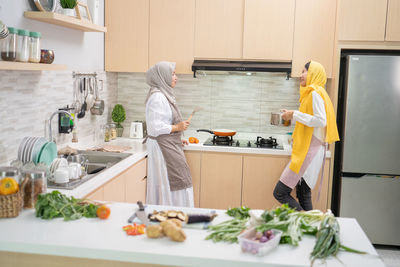 Woman standing by food at home