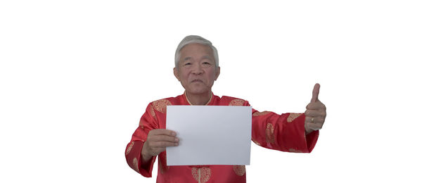 Portrait of man standing against white background