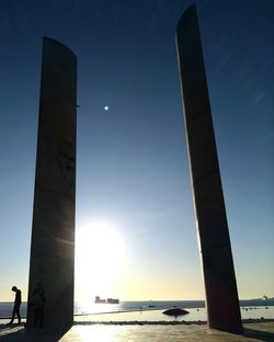 Low angle view of silhouette built structure against sky