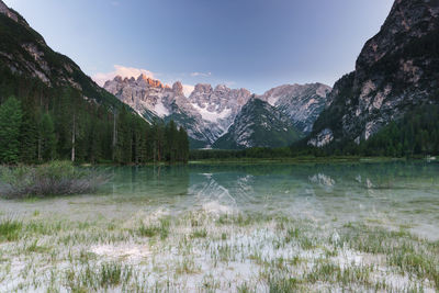 Scenic view of lake and mountains against sky