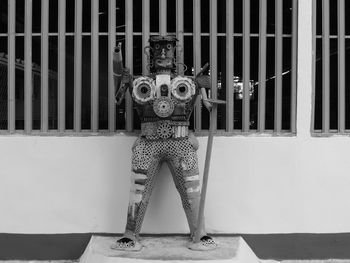 Portrait of mannequin against wall