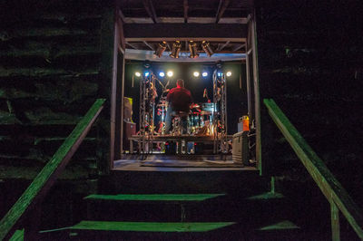People in illuminated staircase at night