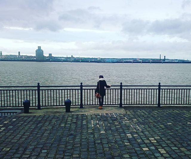 water, sky, architecture, built structure, rear view, building exterior, city, railing, full length, sea, river, men, pier, cloud - sky, cloud, standing, lifestyles, leisure activity