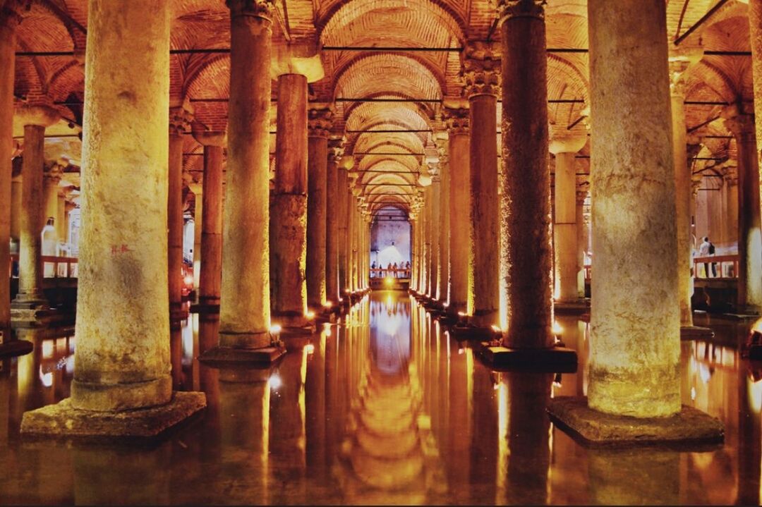 indoors, architecture, arch, built structure, architectural column, the way forward, illuminated, interior, diminishing perspective, empty, column, history, corridor, in a row, ceiling, absence, vanishing point, no people, religion, travel destinations