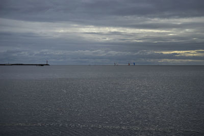 View of calm sea against cloudy sky