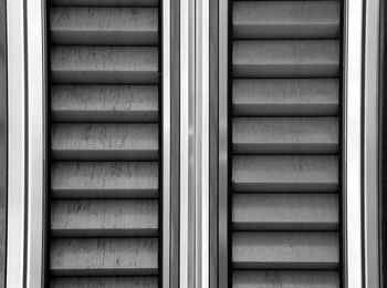 Escalator with steel steps inside a big shopping mall