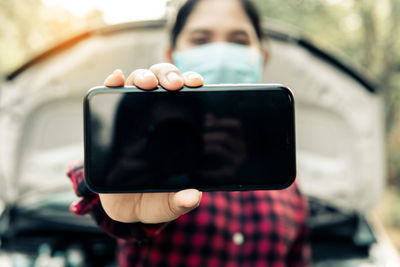 Midsection of man using mobile phone