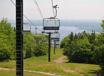 Low angle view of electricity pylons against sky