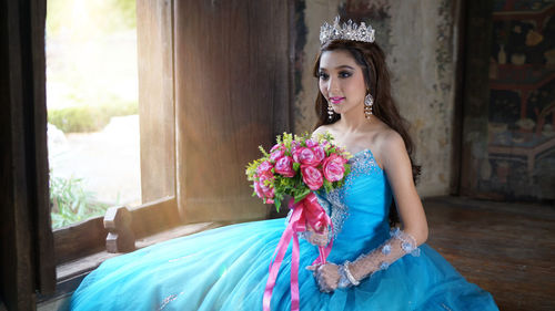 Beautiful woman holding flower bouquet