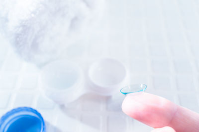 Close-up of hand holding blue glass