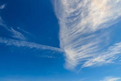 Low angle view of vapor trail in blue sky