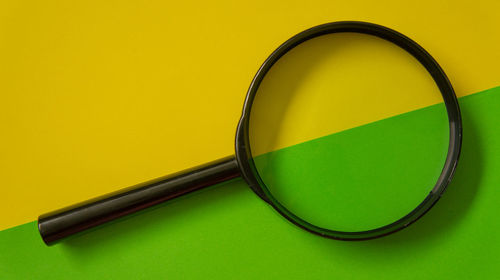 High angle view of yellow glass on table