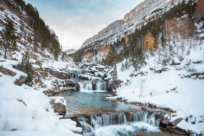 Scenic view of frozen lake against sky during winter