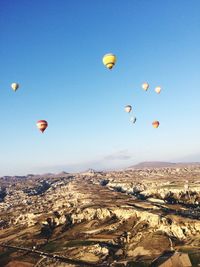 Hot air balloons flying over landscape at cappadocia