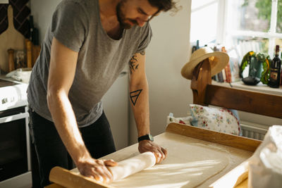 Man rolling dough