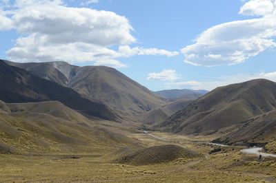 Scenic view of mountains against cloudy sky