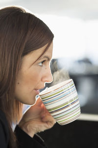 Businesswoman having coffee in office