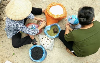 High angle view of people sitting on beach