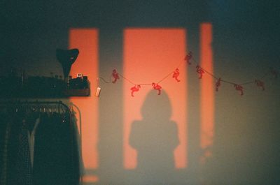 Close-up of hanging light against building