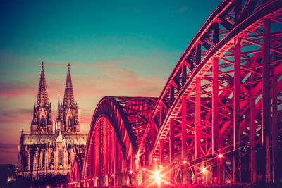 Hohenzollern bridge by cologne cathedral at night