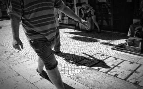 Low section of man standing on street