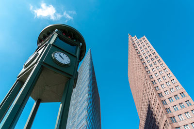 Low angle view of modern buildings against blue sky